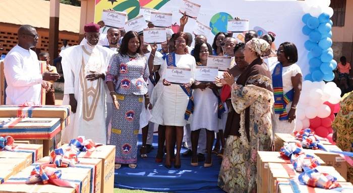 The Ayawaso East Municipal Assembly presents a certificate of appreciation to 16 teachers.