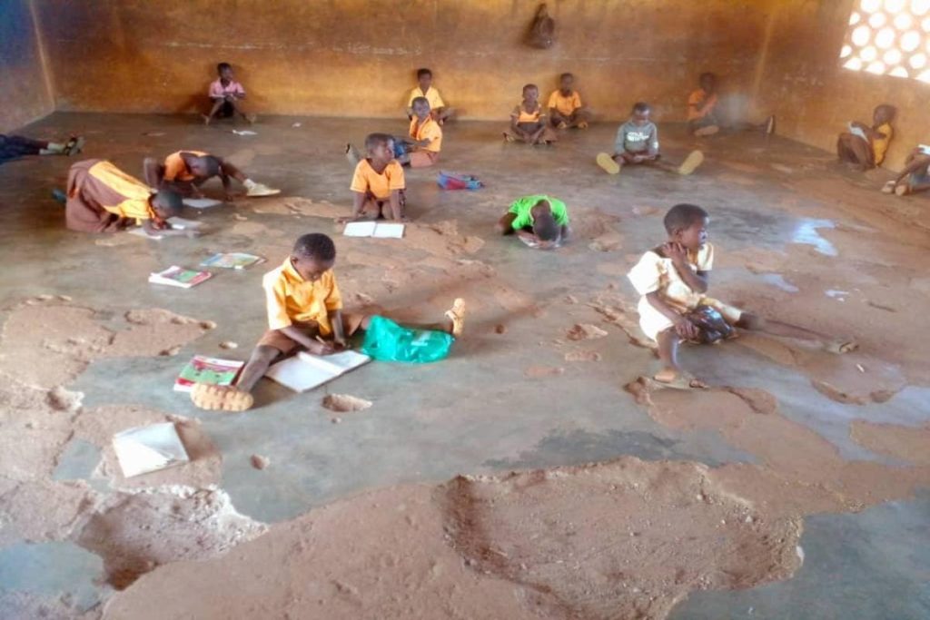 basic school pupils study on bare floors in Ghana